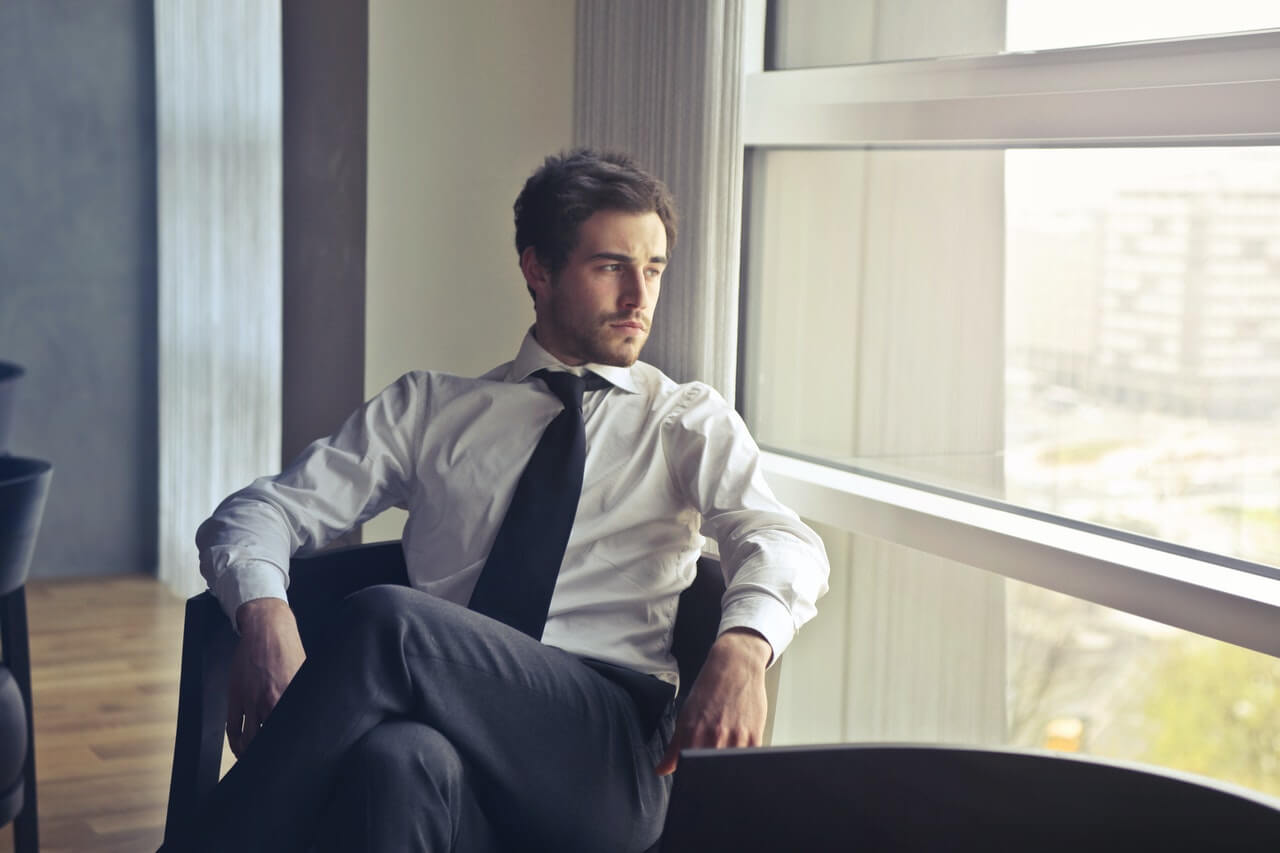 Businessman looking out through his office window