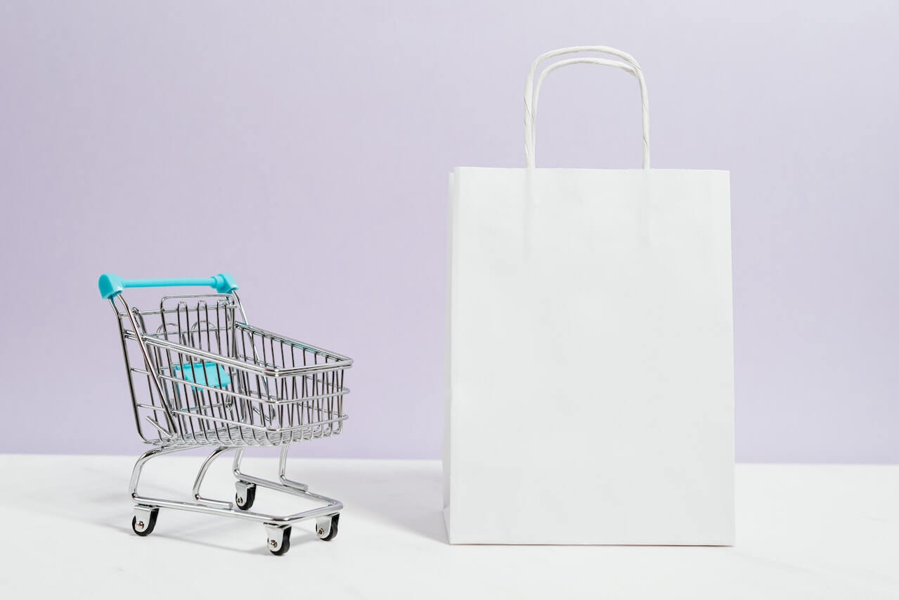 A pushcart and a white paperbag