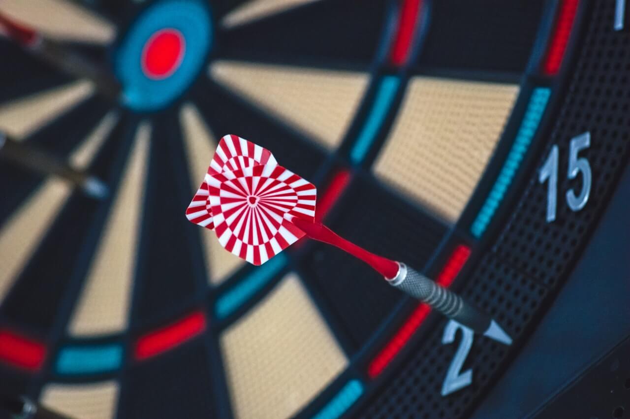 Red and white stripped dart pin on a dartboard