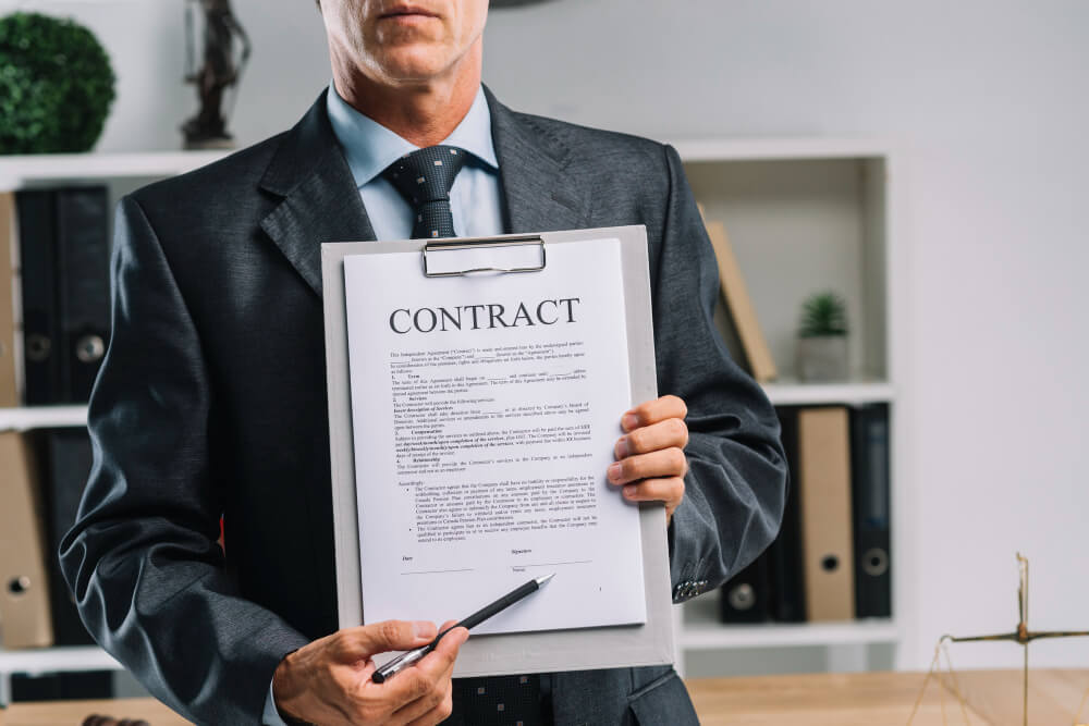 Close up of a lawyer holding a legal contract document and a pen