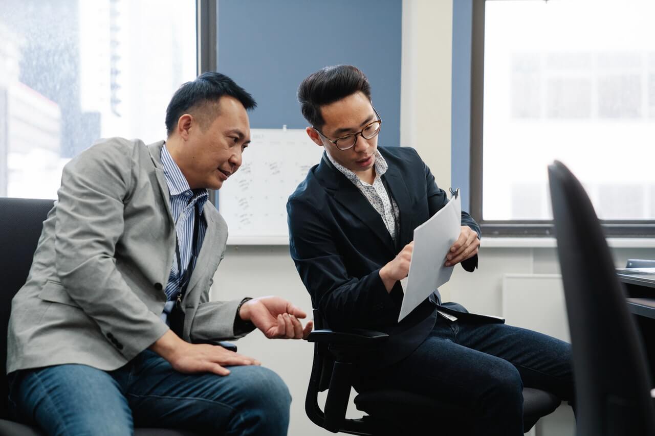 Two men looking at a business document