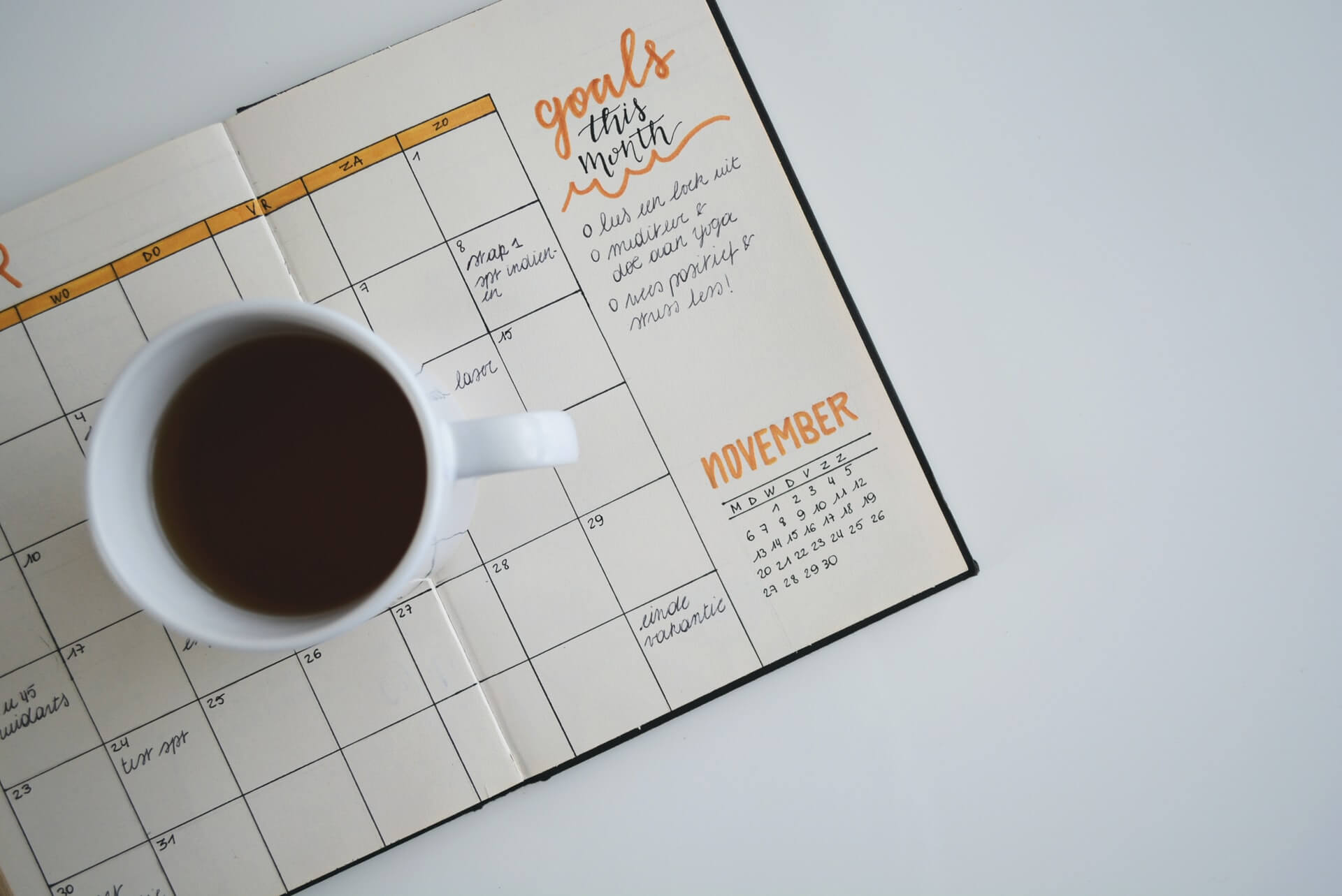 Coffee mug on top of a goal planner