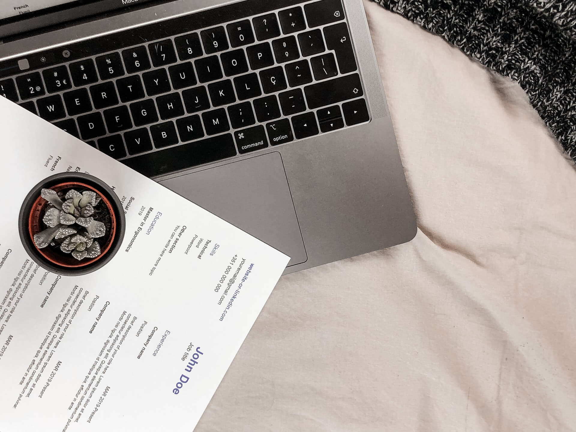 A resume lying on a laptop