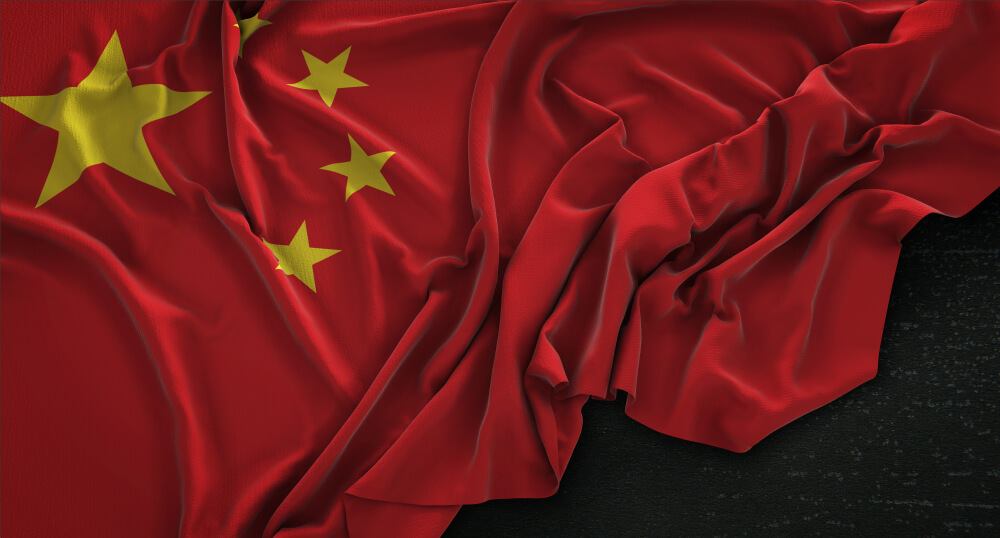 Wrinkled Chinese flag on a dark background