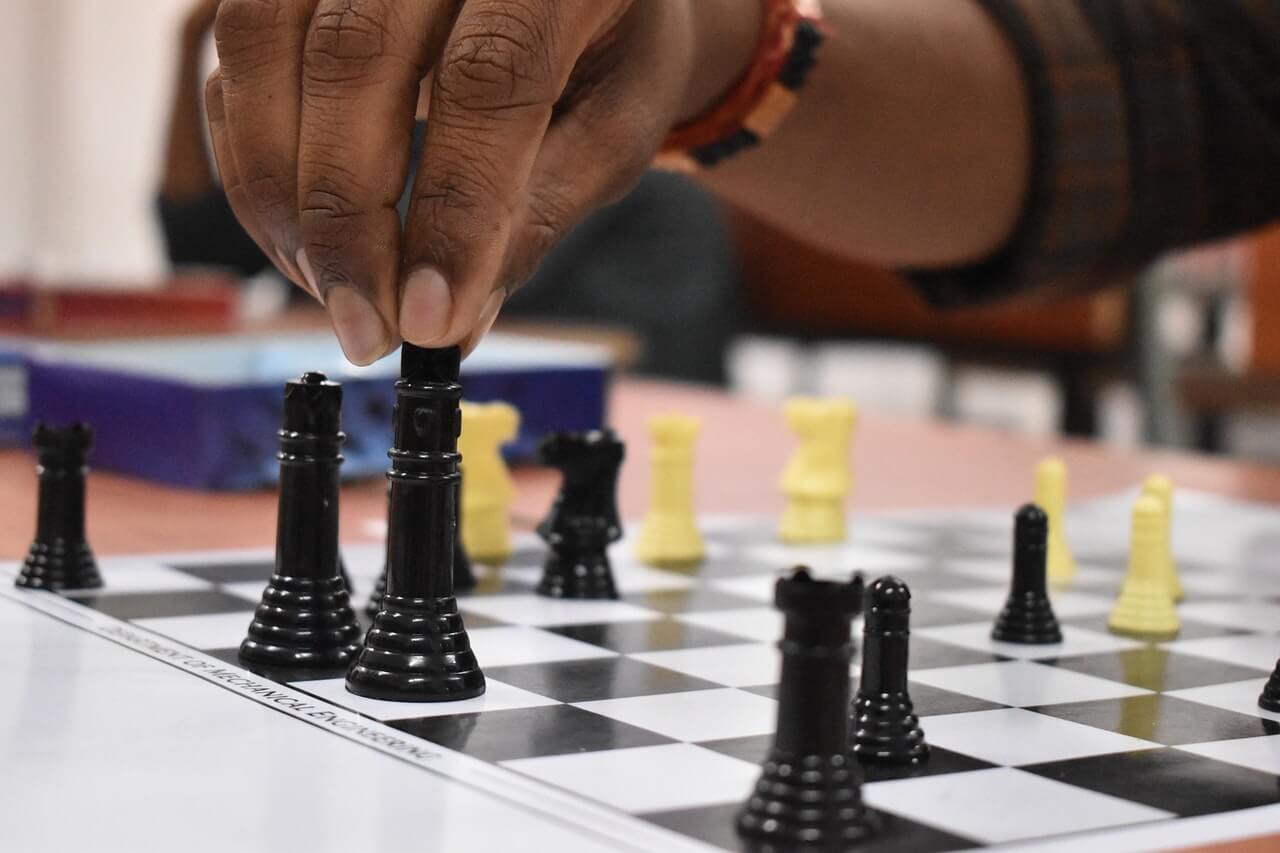 A hand playing chess