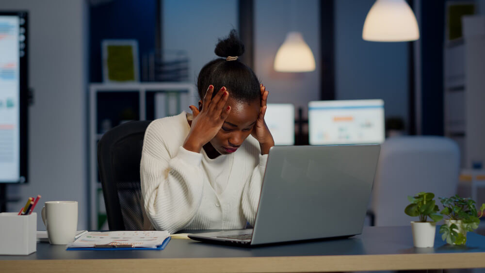 Stressed woman tired from working on her laptop