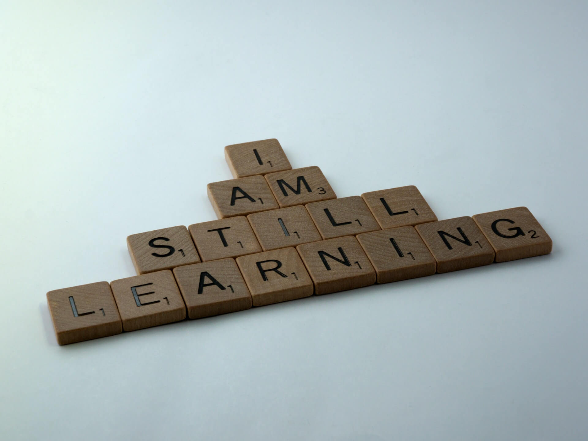 Brown wooden blocks with the text "I am still learning"