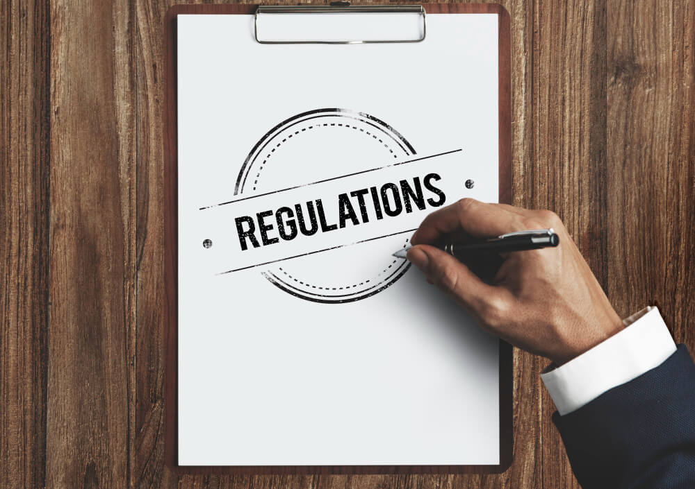 The word regulation on a white paper