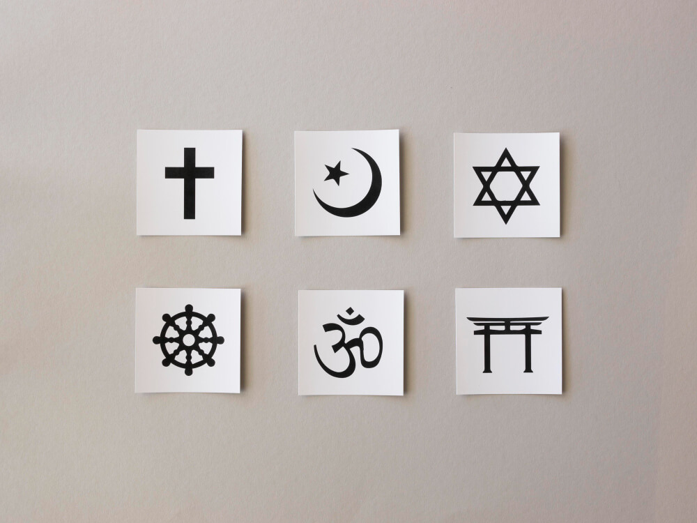 Different religions drawn on papers glued to a plain background