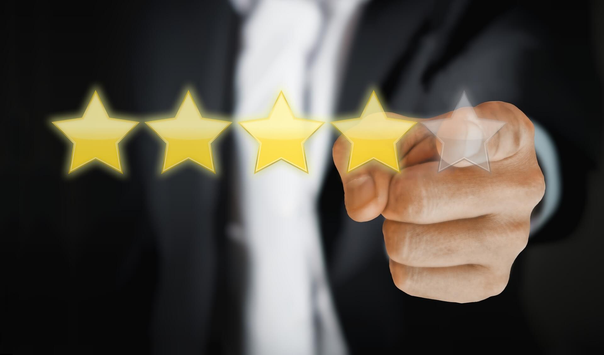 Person in suit pointing at star ratings