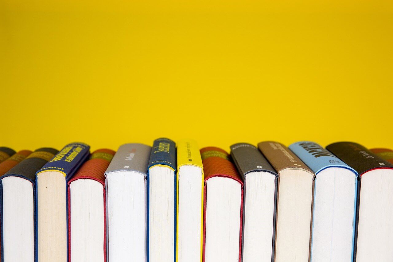 Stacks of books on a yellow background