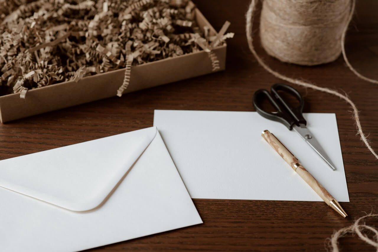 White envelope on a brown desk