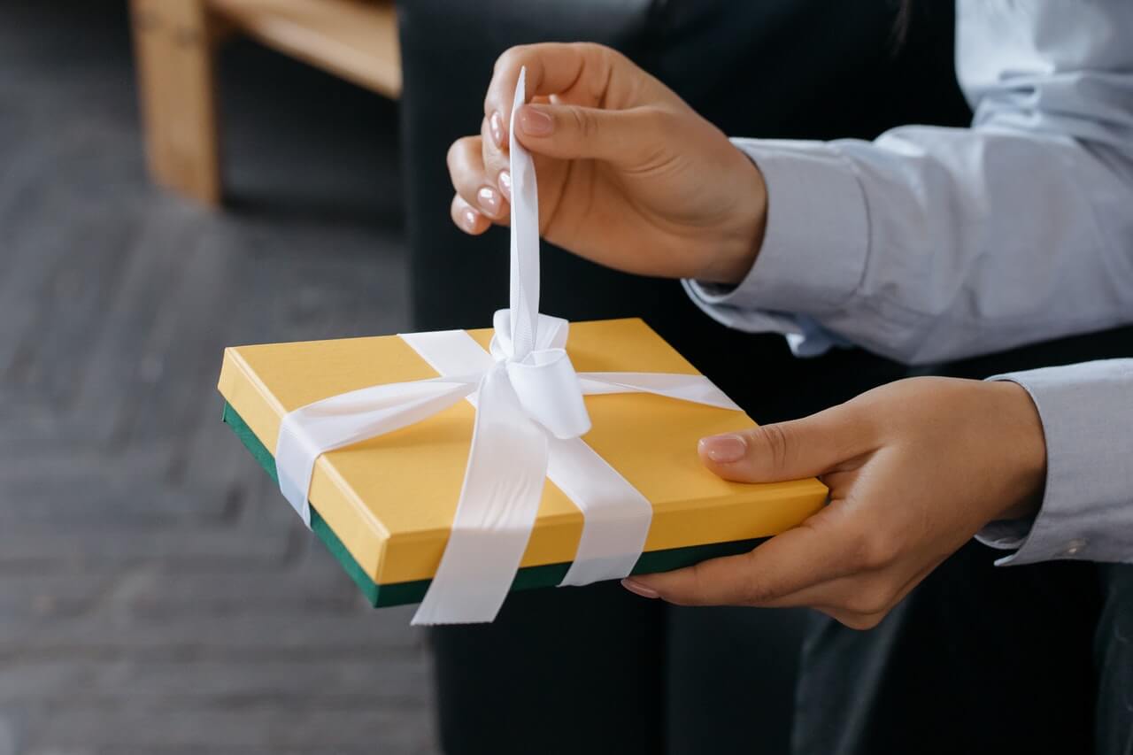 Person untying a gift box