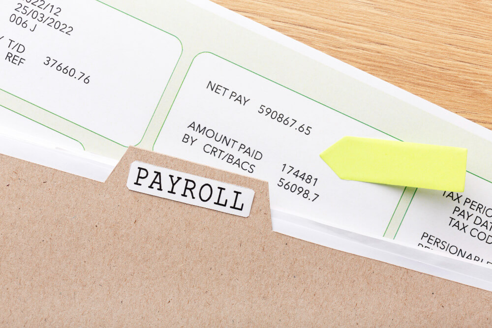 Payroll documents on the desk