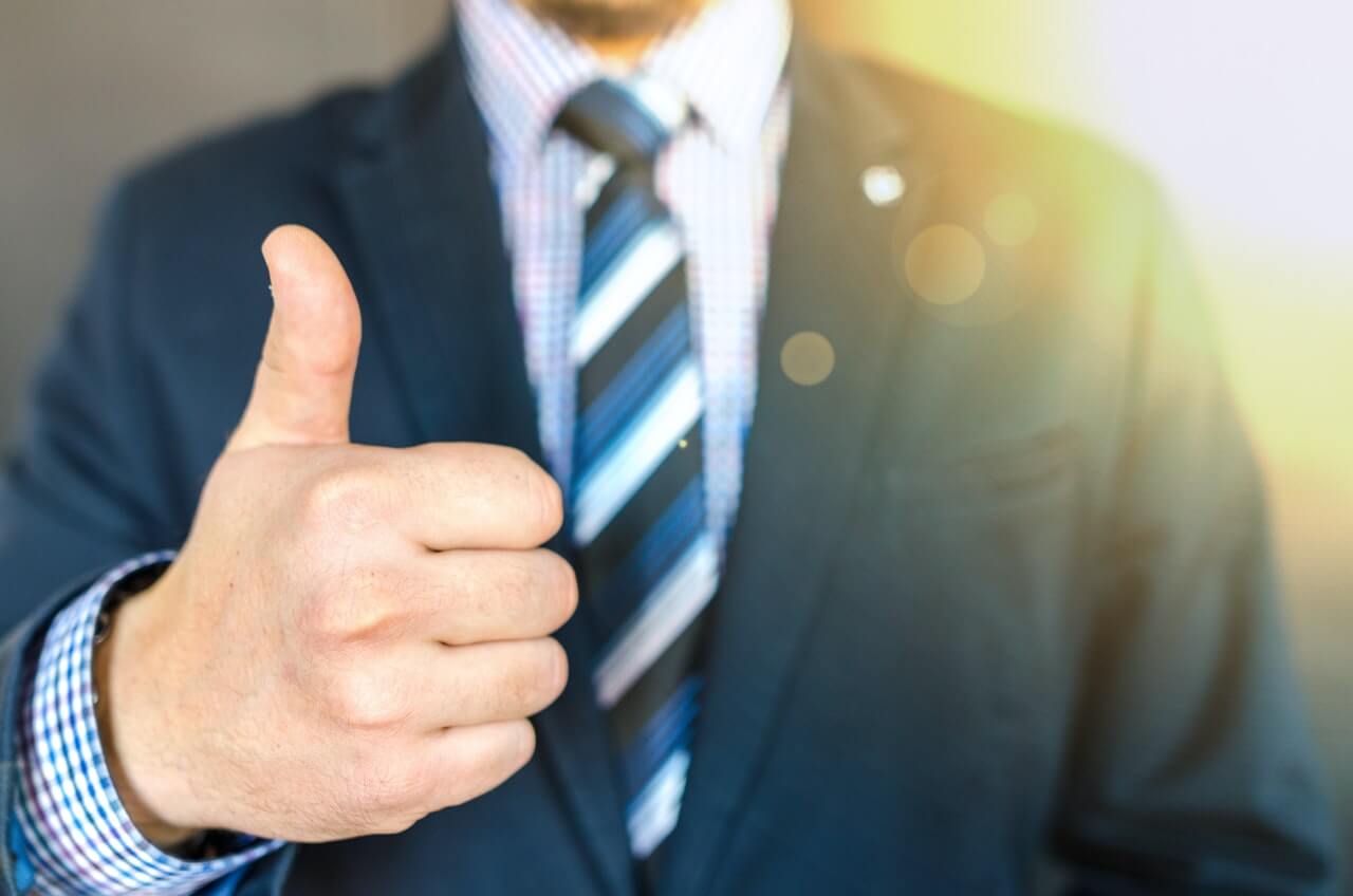 Man in suit doing thumbs up