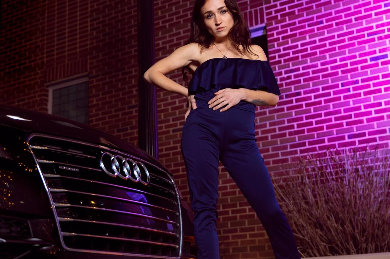 A-lady-standing-beside-an-Audi-car