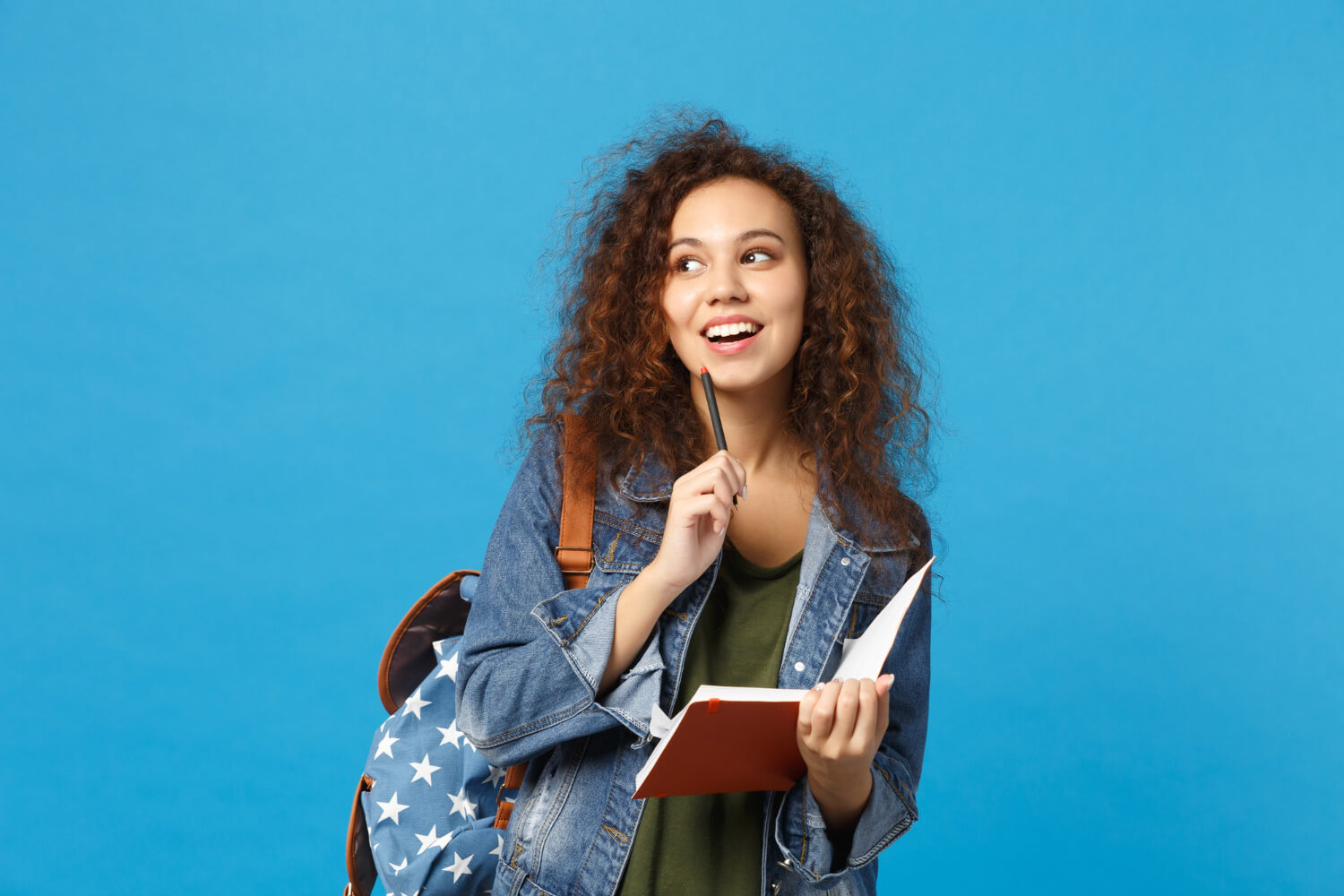 A-young-student-carring-her-notebook-in-a-blue-background