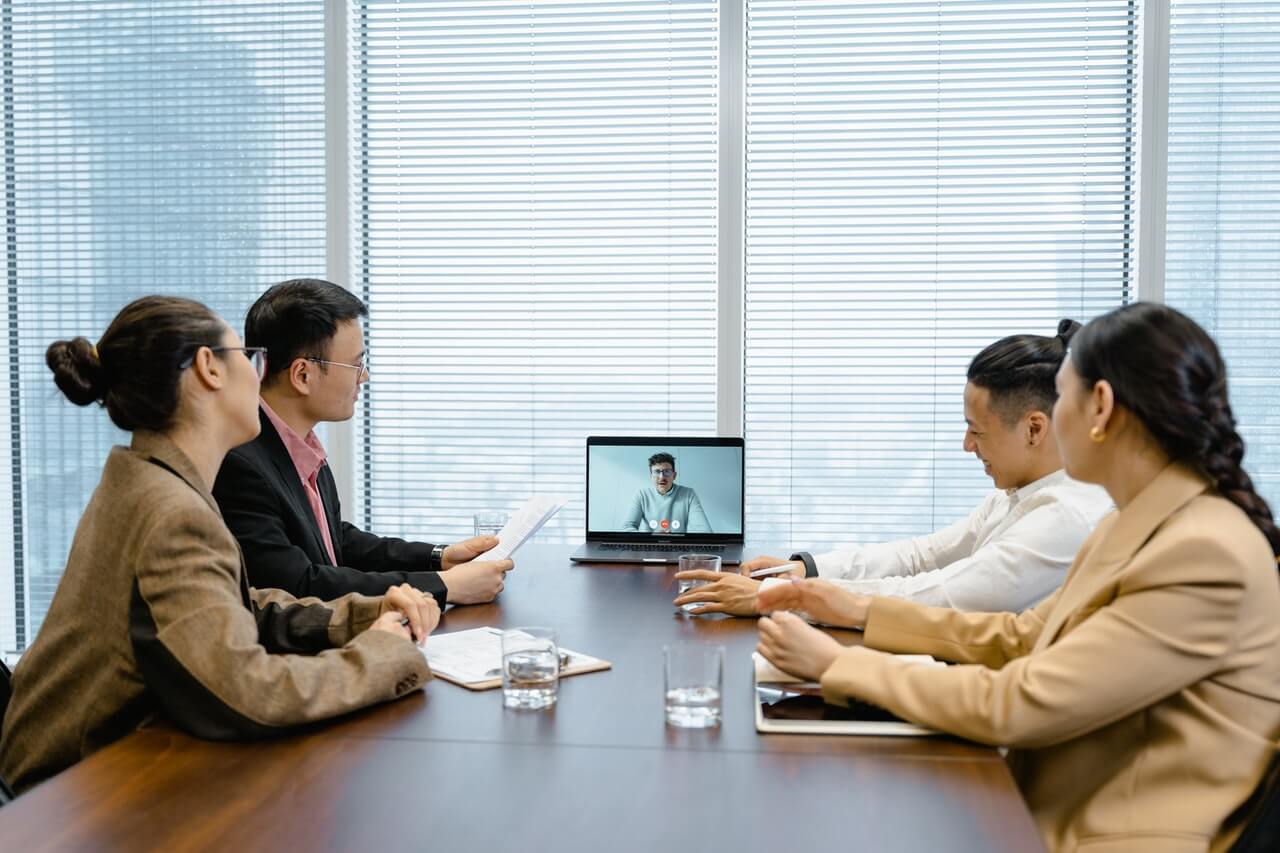 A-group-of-workers-communicating-with-a-employer-with-a-laptop-in-a-meeting