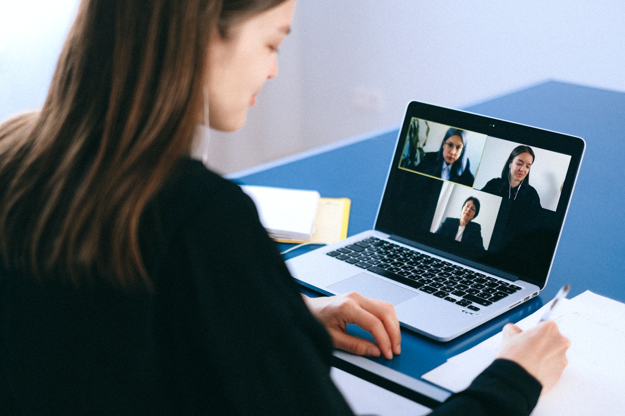 A lady having a virtual meeting using a laptop