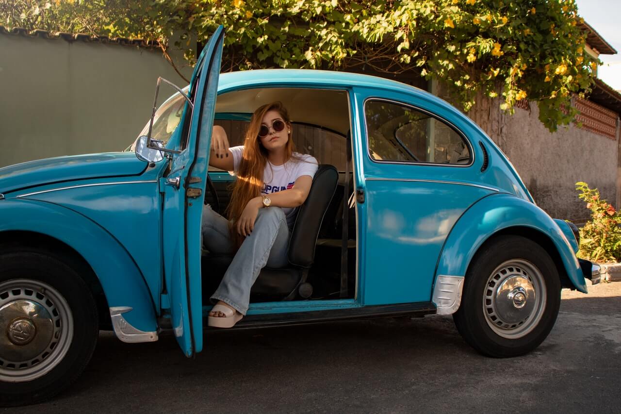 A-lady-sitting-inside-a-volkswagen-car-and-looking-at-the-camera