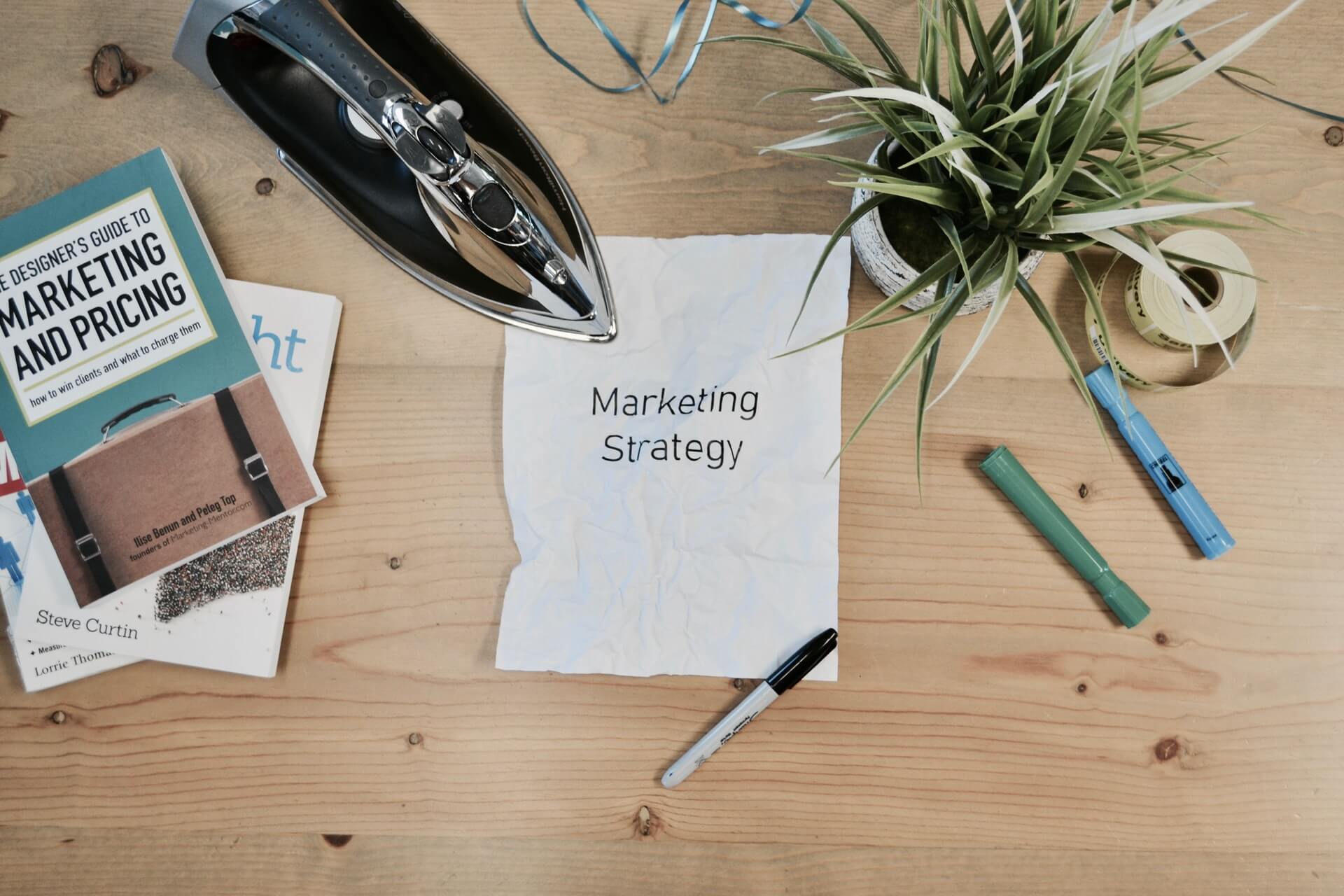A marketing strategy written on a note placed on a desk