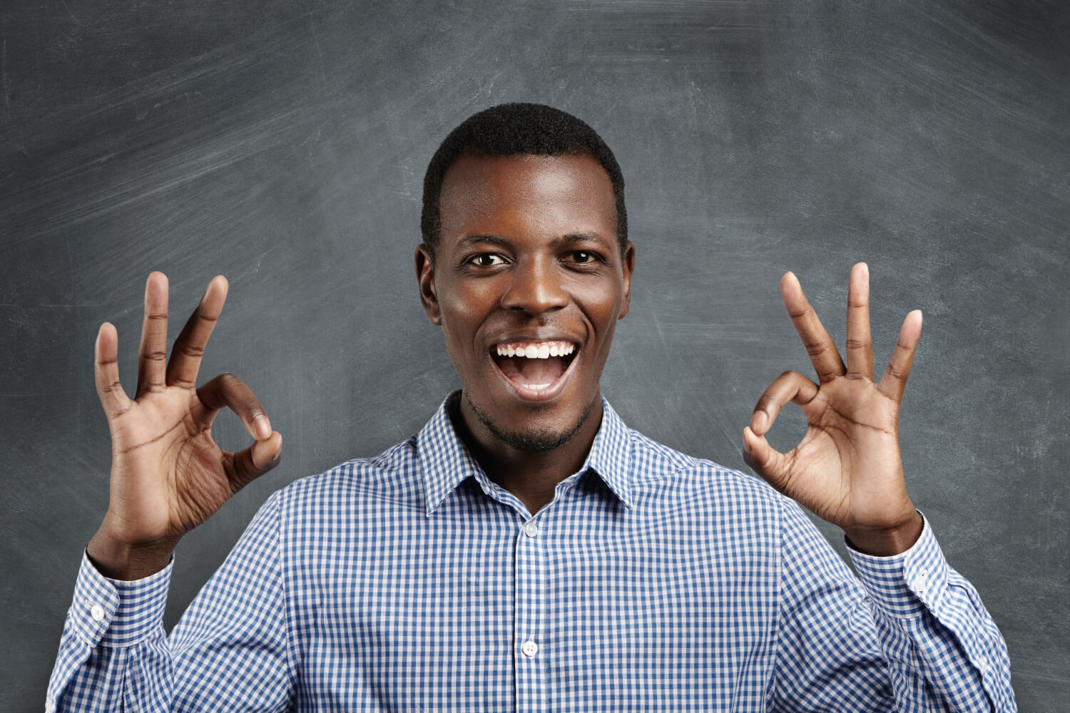 Young business man gesturing showing ok sign