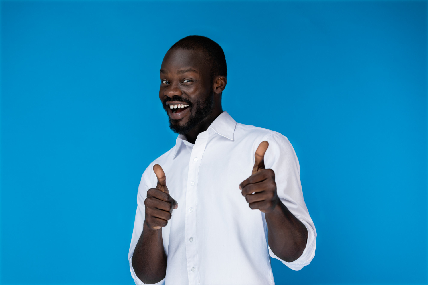 Man shows his thumbs up while smiling