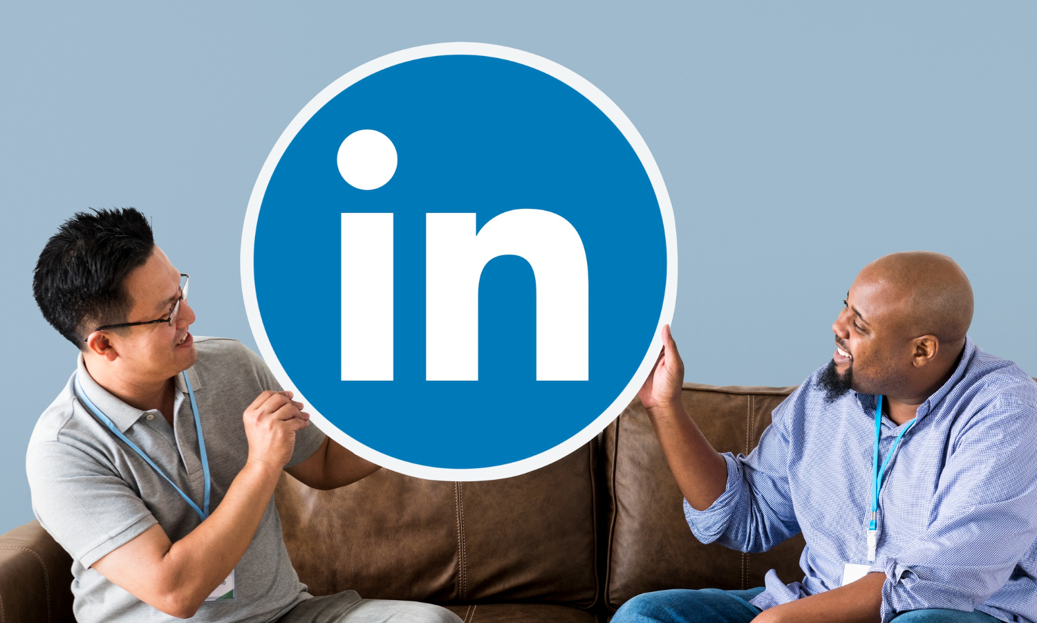 Men seated on a couch holding linkedin logo