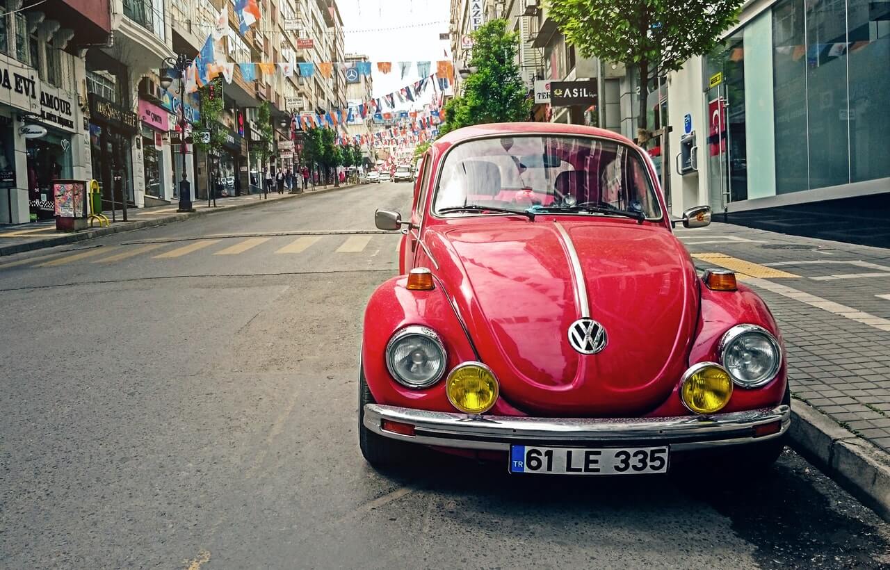 Red-volkswagen-beetle-car-parked-outside