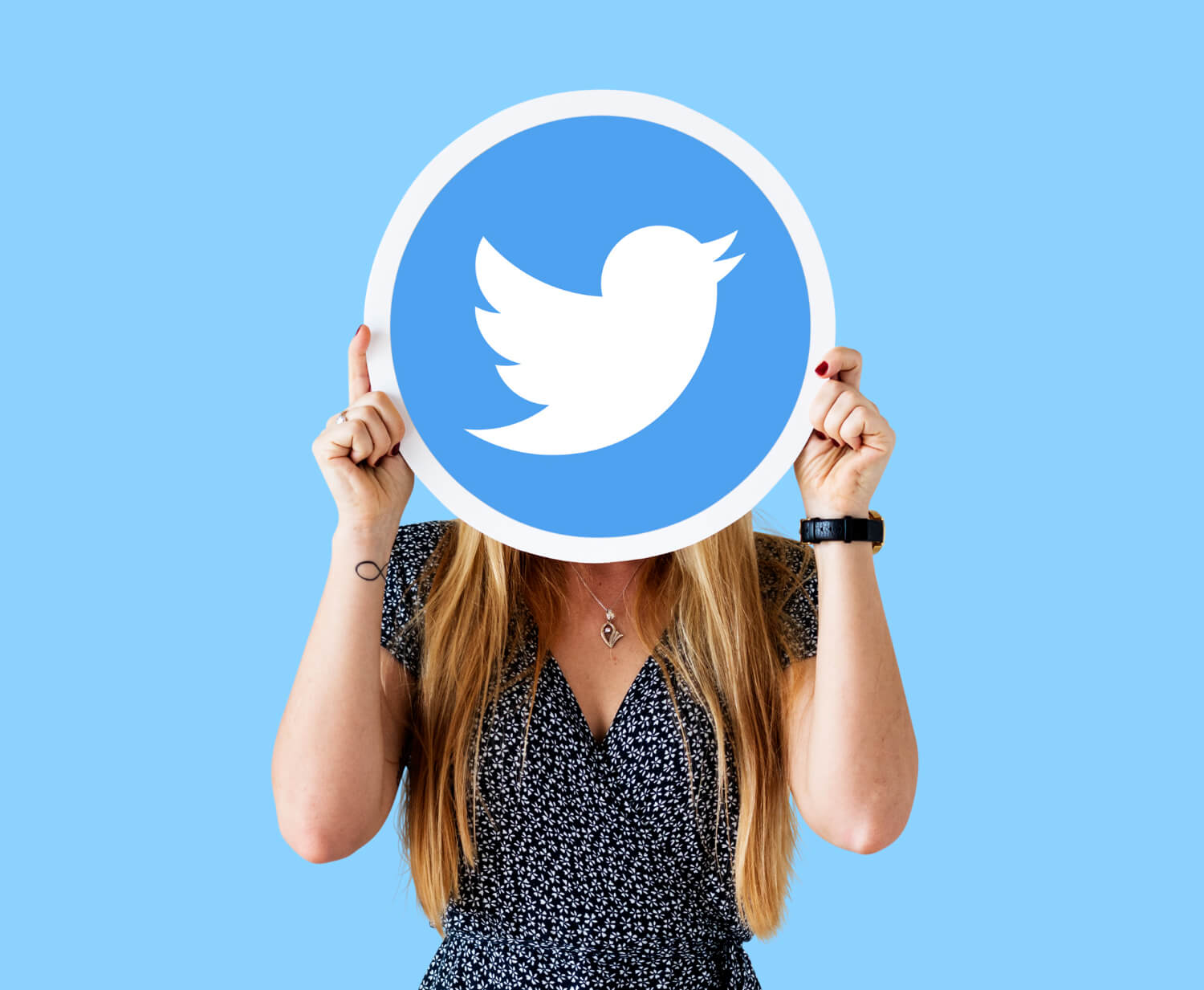 A lady holding a twitter sign