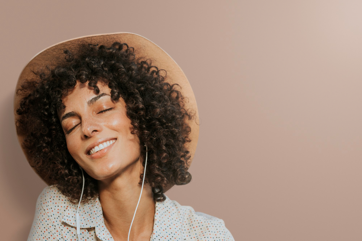 Woman wearing earphones and smiling happily