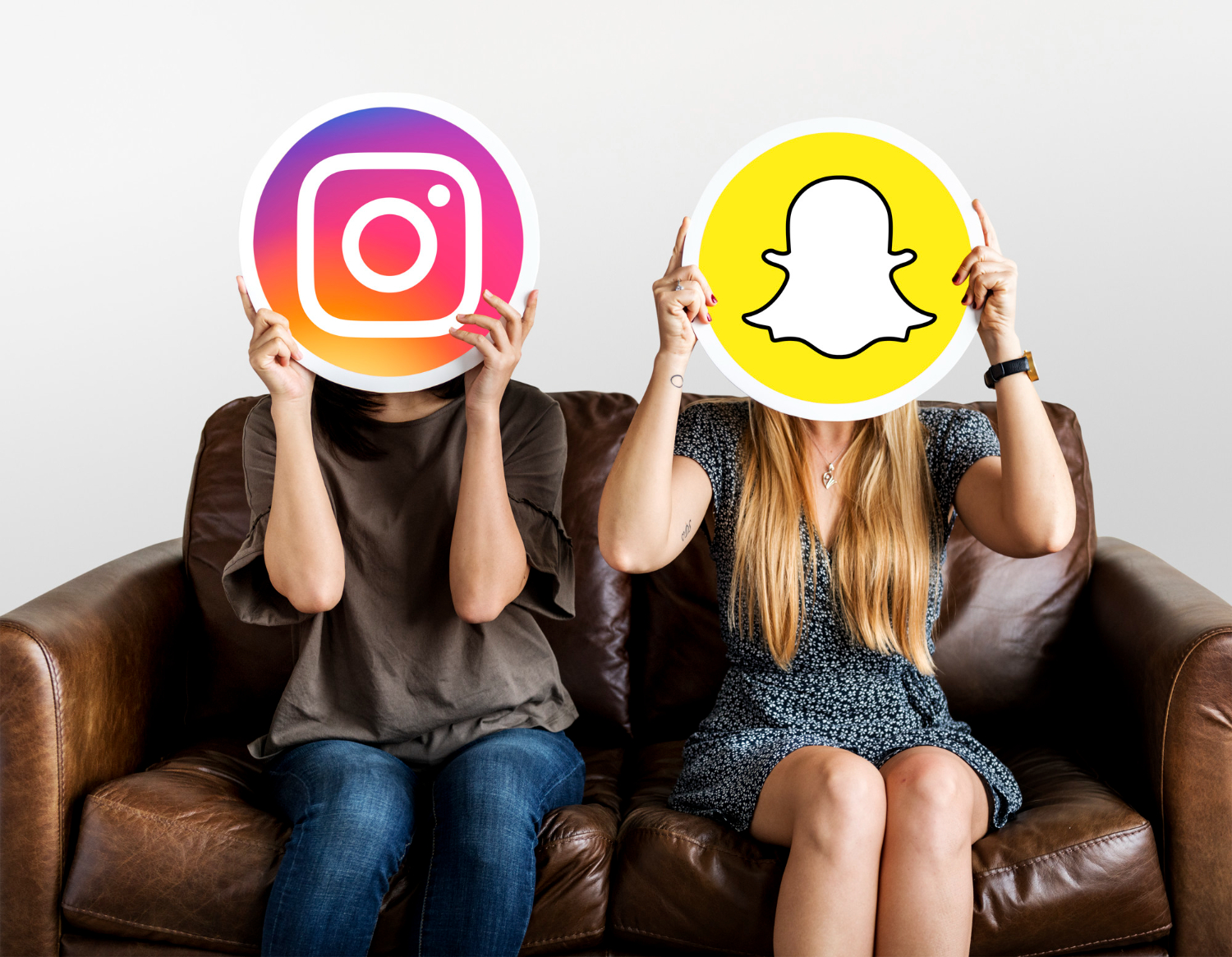 Women-holding-an-instagram-icon-and-a-snapchat-icon
