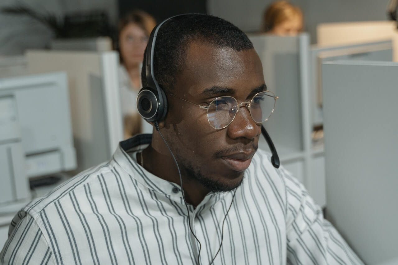 Man in a button up shirt wearing a headphone