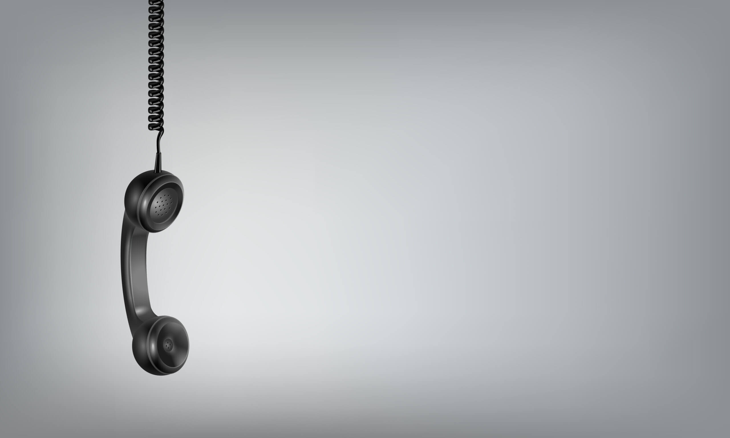 Black telephone in a gray background
