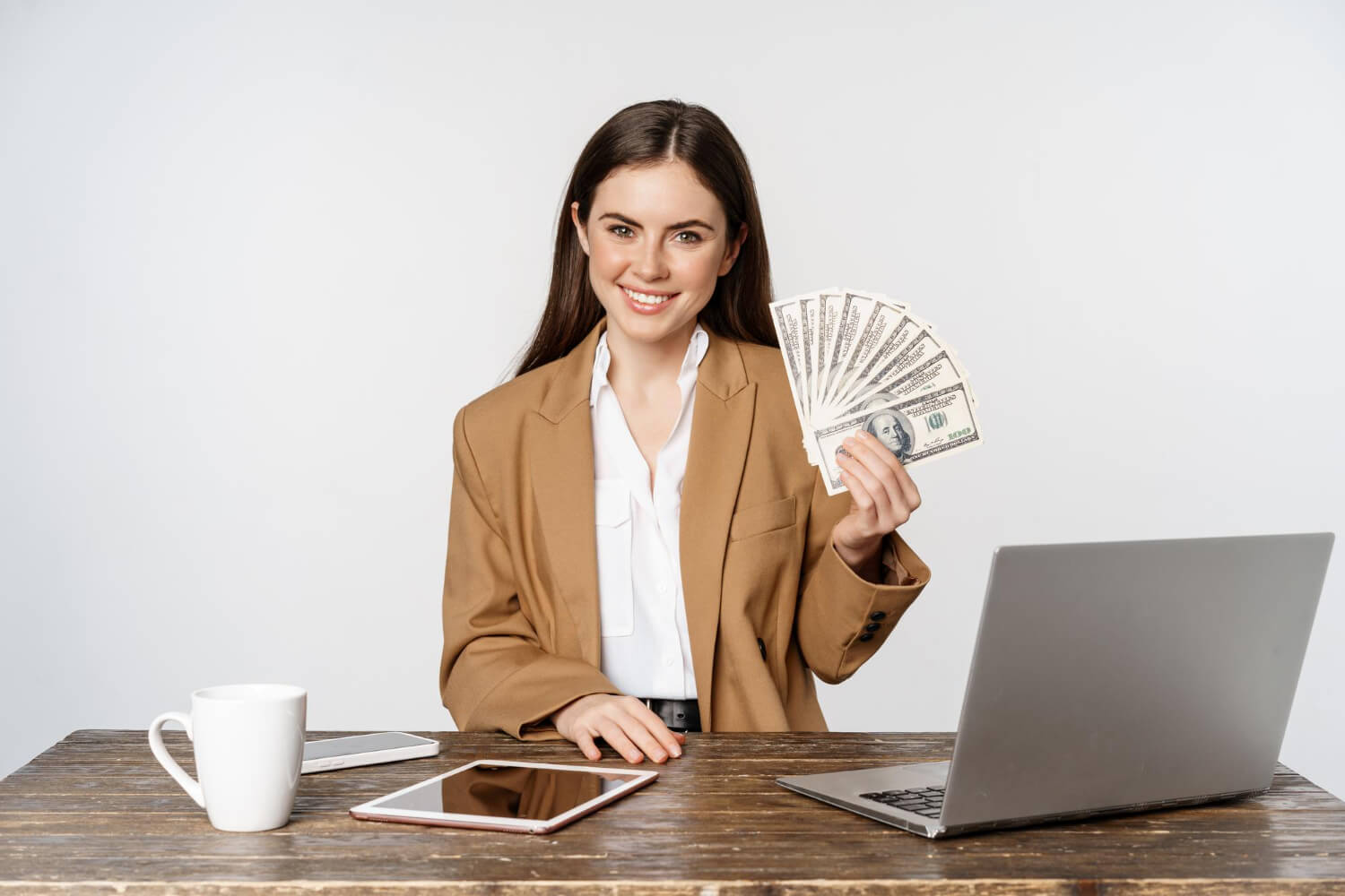 young lady in an office holding cash
