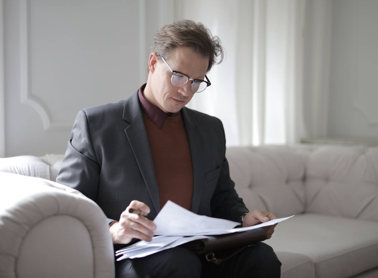 Businessman reading papers on the couch