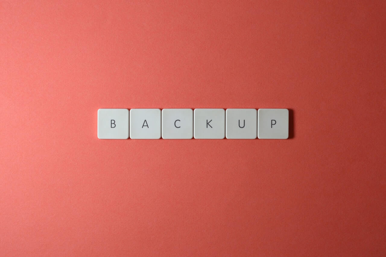 Buttons letters saying backup in a red background