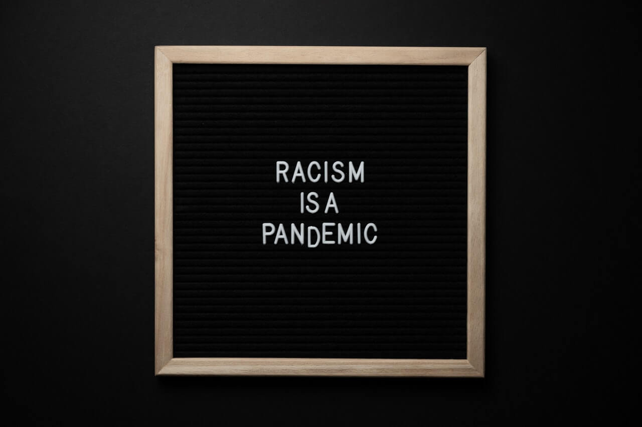 Racism-is-a-pandemic-written-on-a-black-bacground