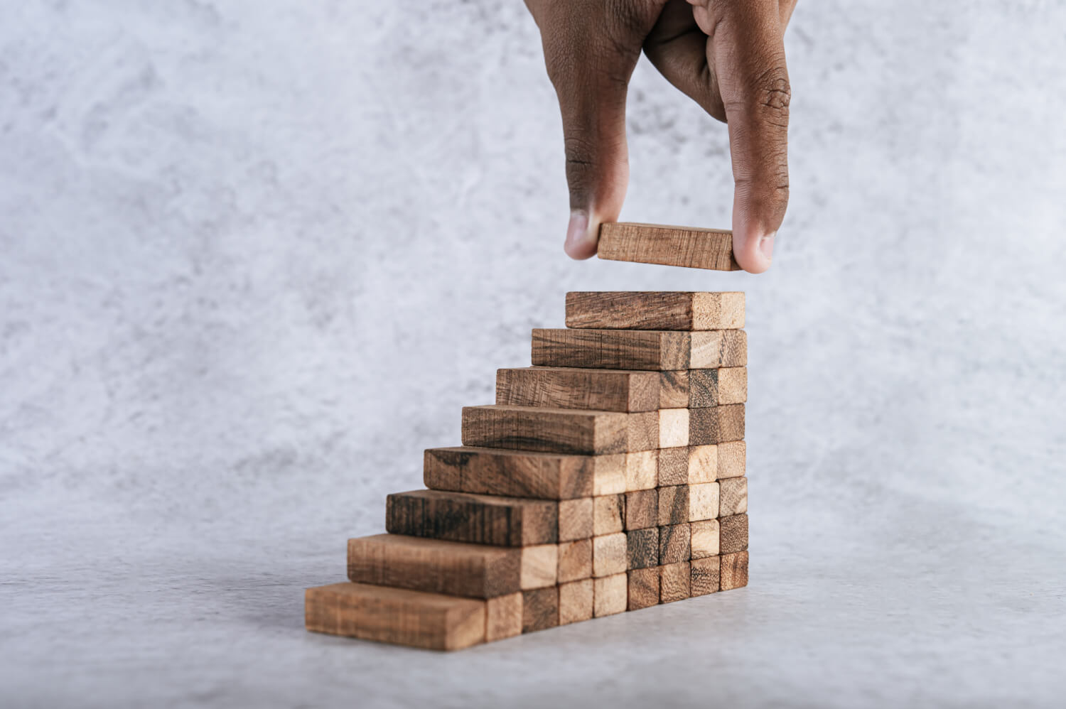 Stacking wooden blocks creating business growth