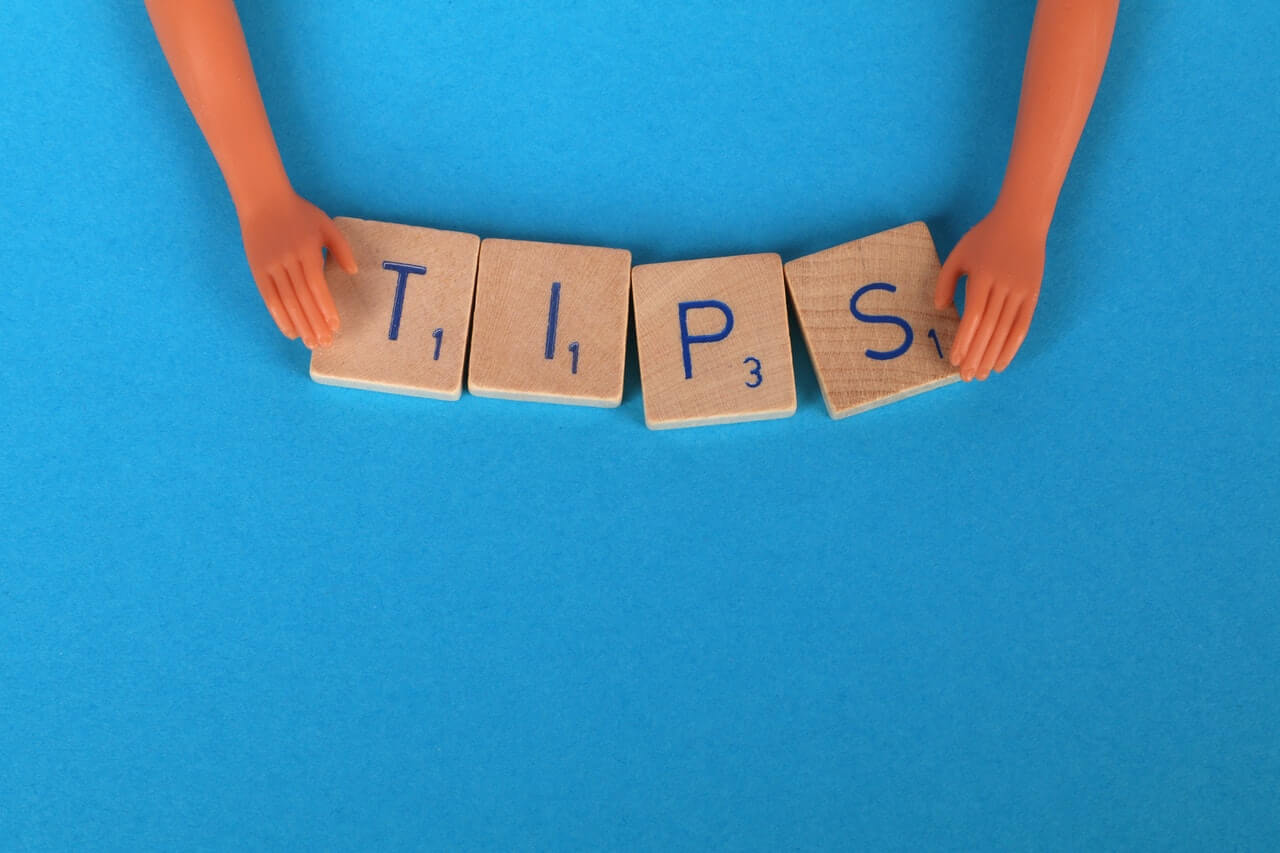 Tips of scrabble letters on a blue background