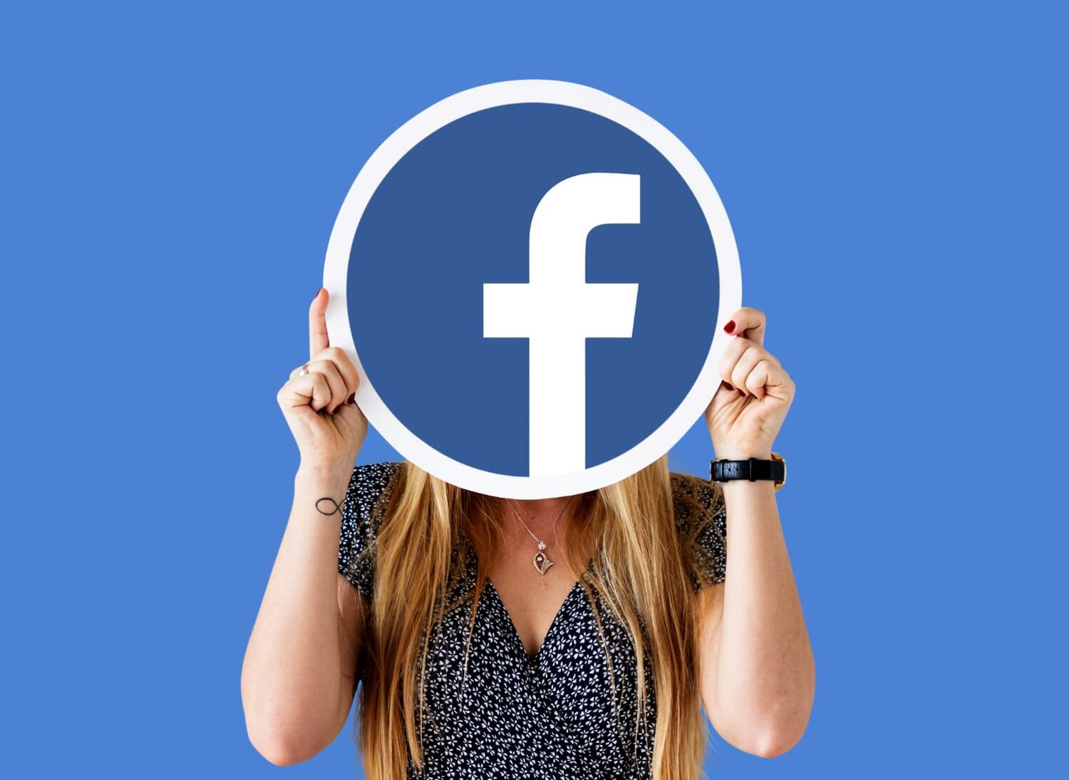 Woman showing facebook icon