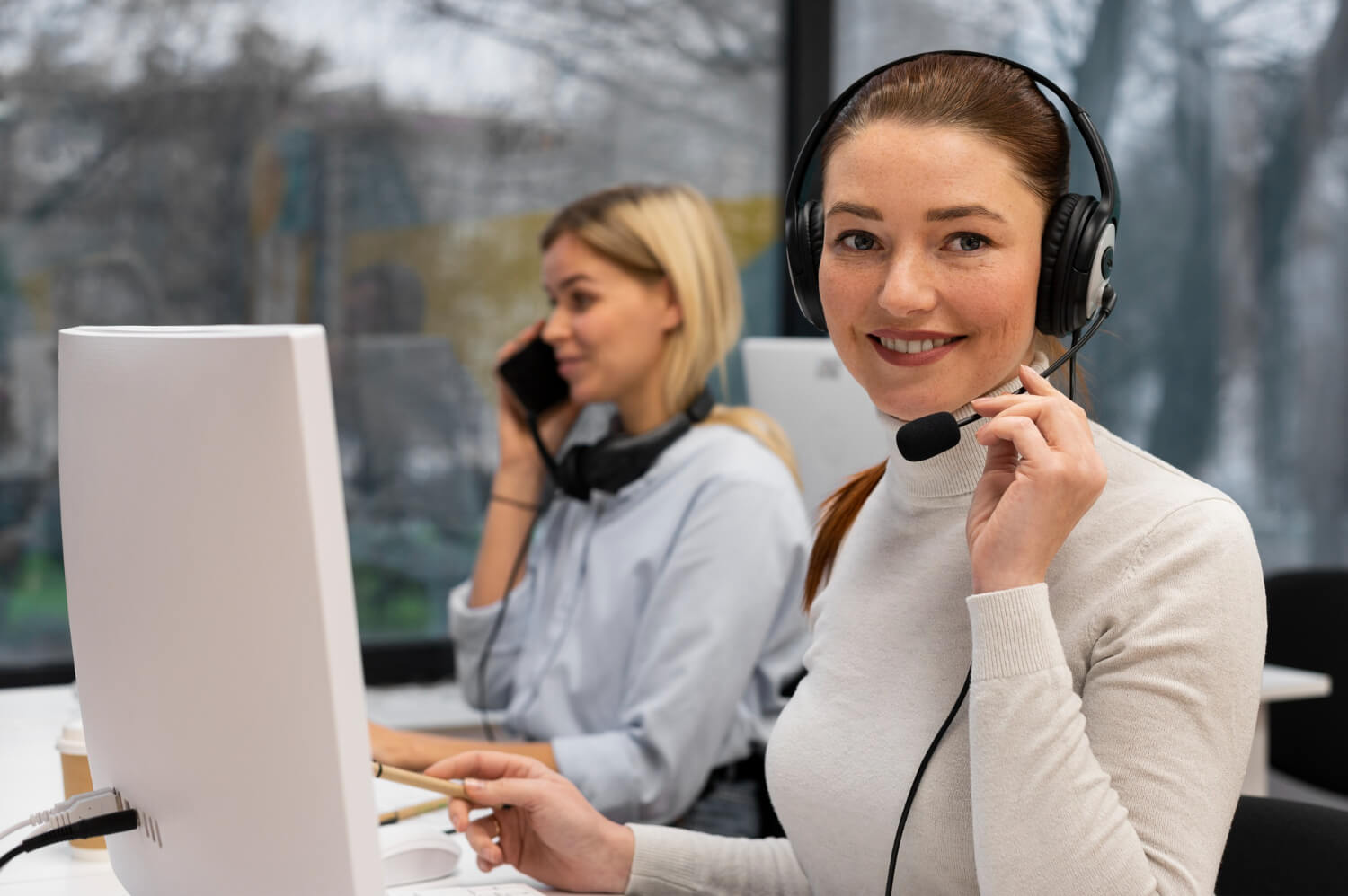 A young lady working in a call center smiling