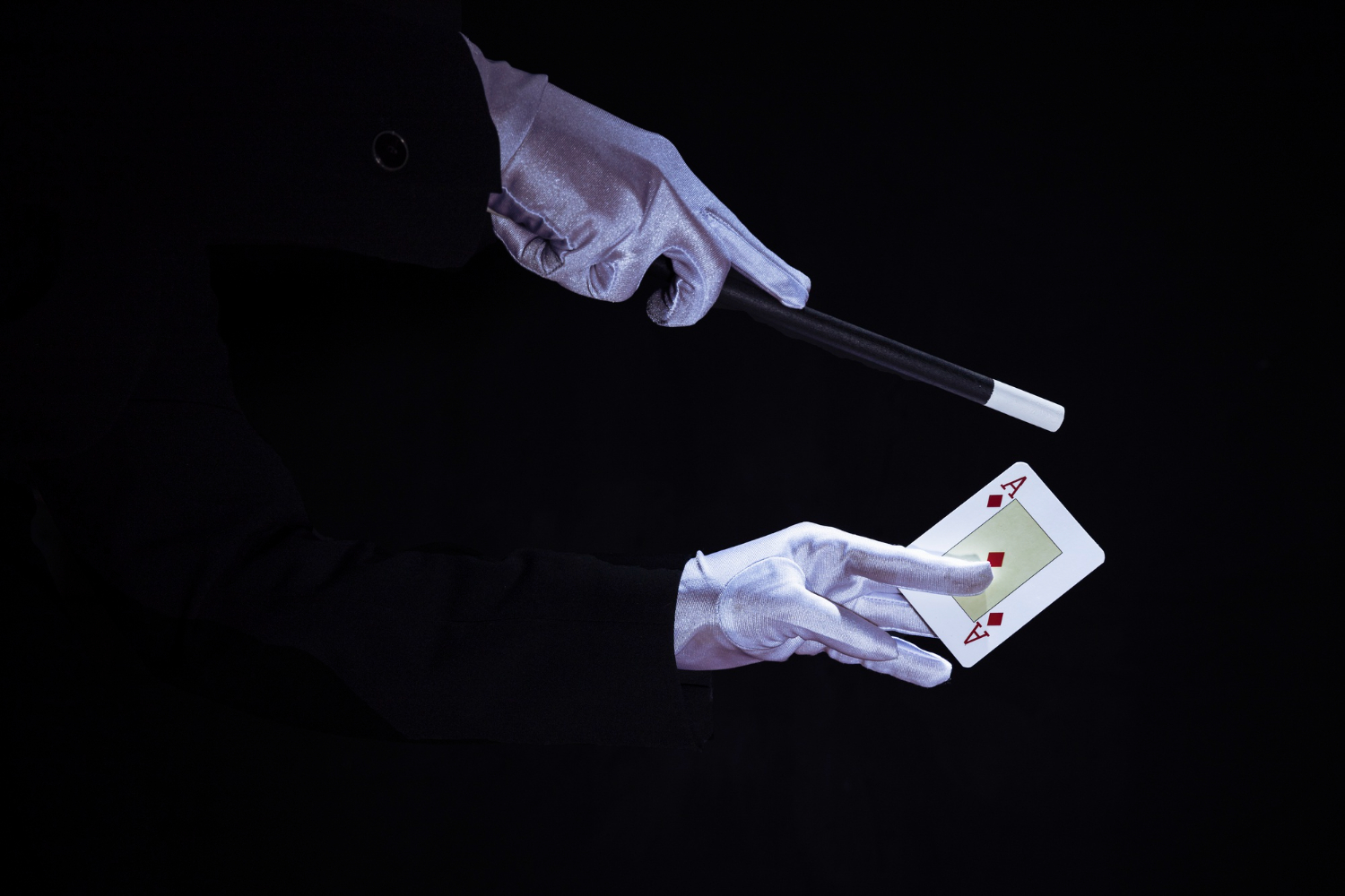 magician-performing-trick-aces-playing-card-against-black-background