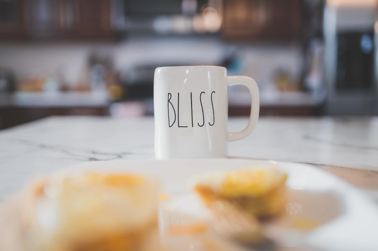 The word "bliss" printed on a ceramic mug