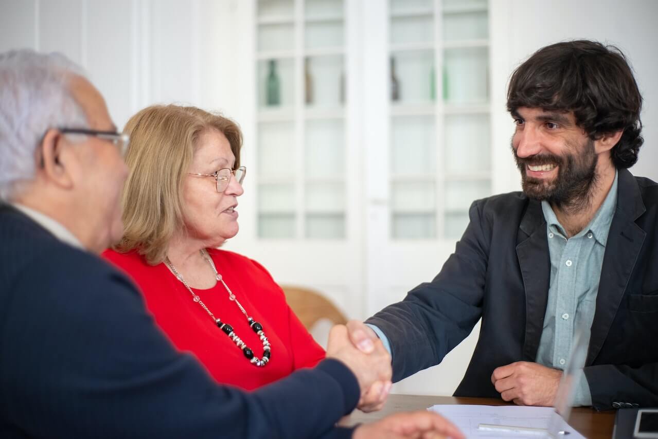 Business manager shaking hands with new clients