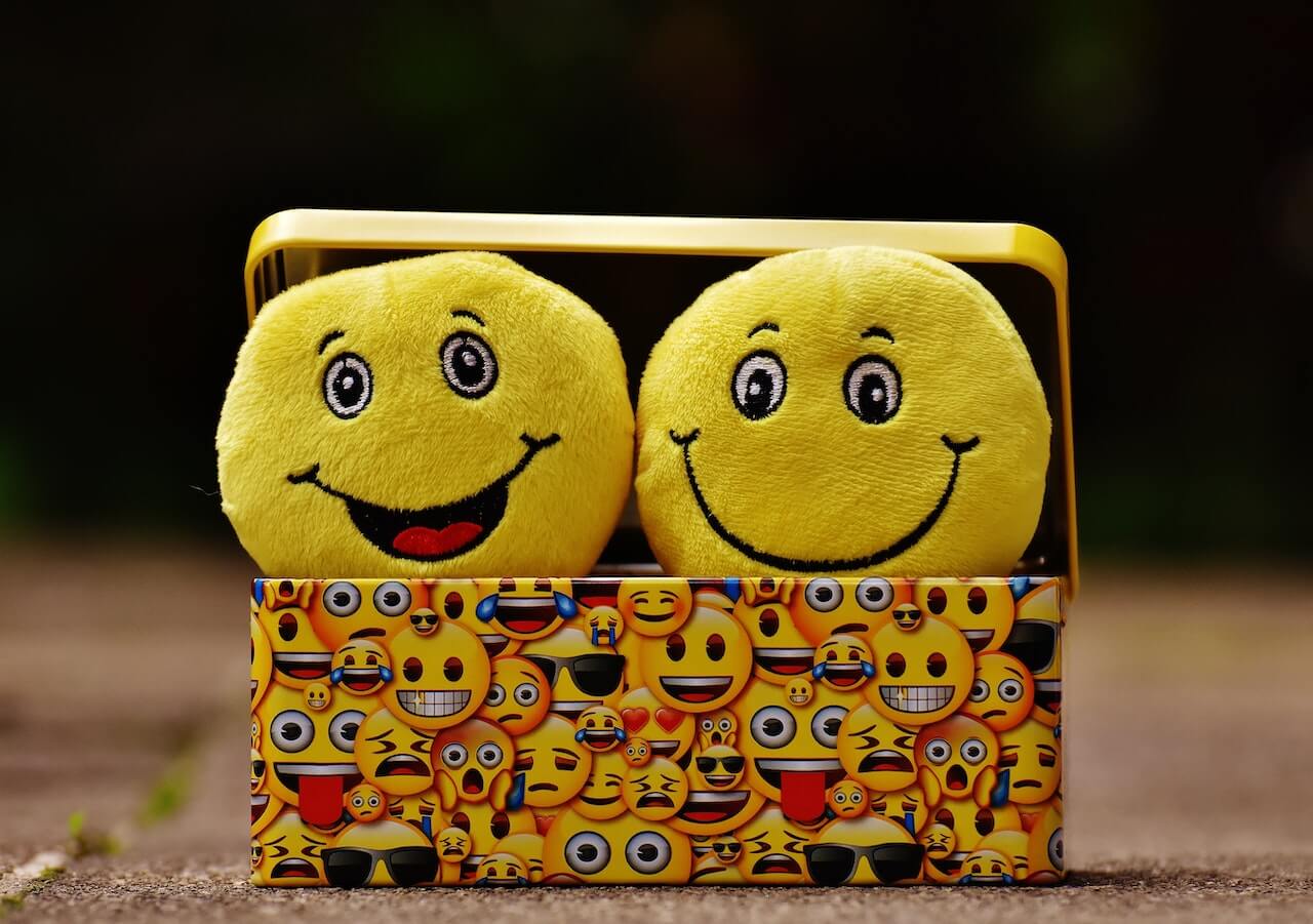 Two yellow happy emojis
