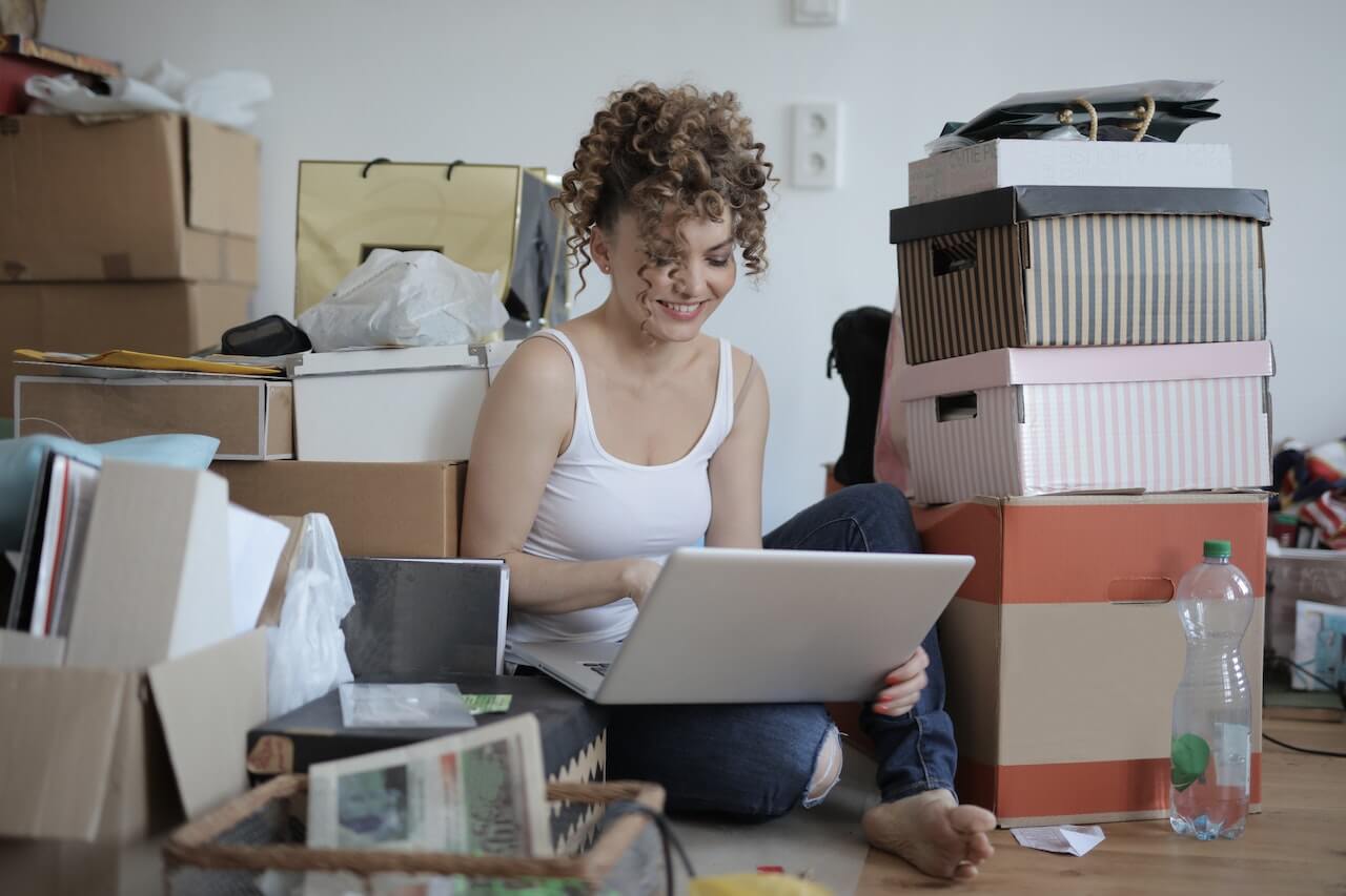 A young woman working in a cluttered space