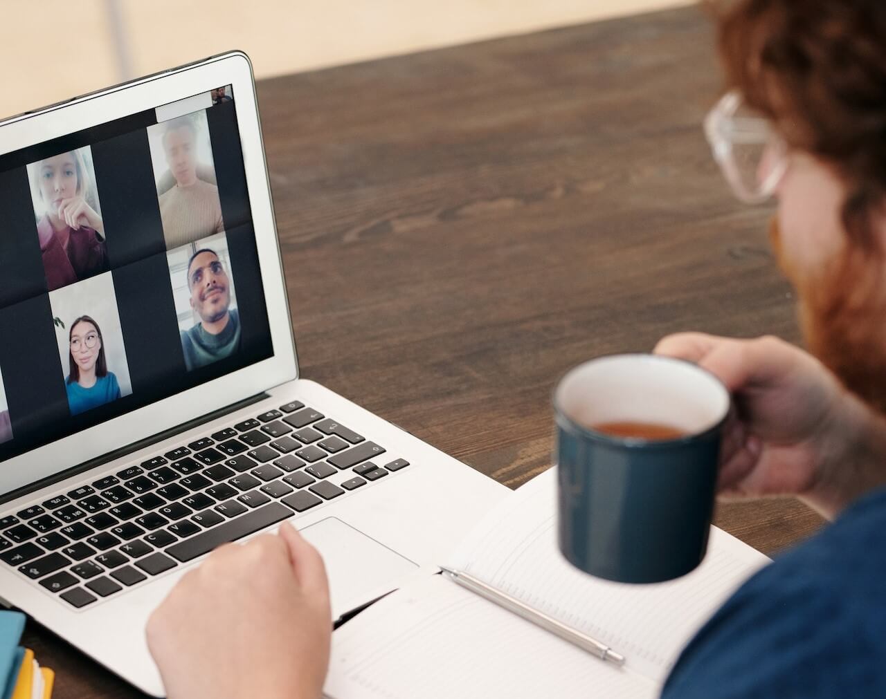 Young man on a video call while holding a mug