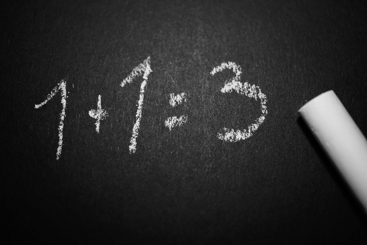 A blackboard showing an incorrect math calculation | 1 += 3