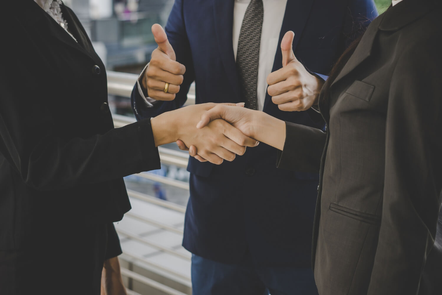 Business people shaking hands finishing up meeting deals